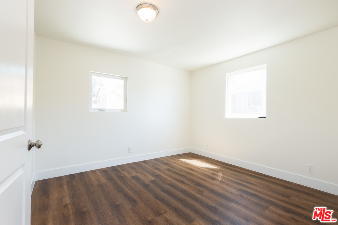 626 Silver Boulevard Los Angeles, CA 90026 - Photo 14 of 24 an empty room with wooden floor and windows
