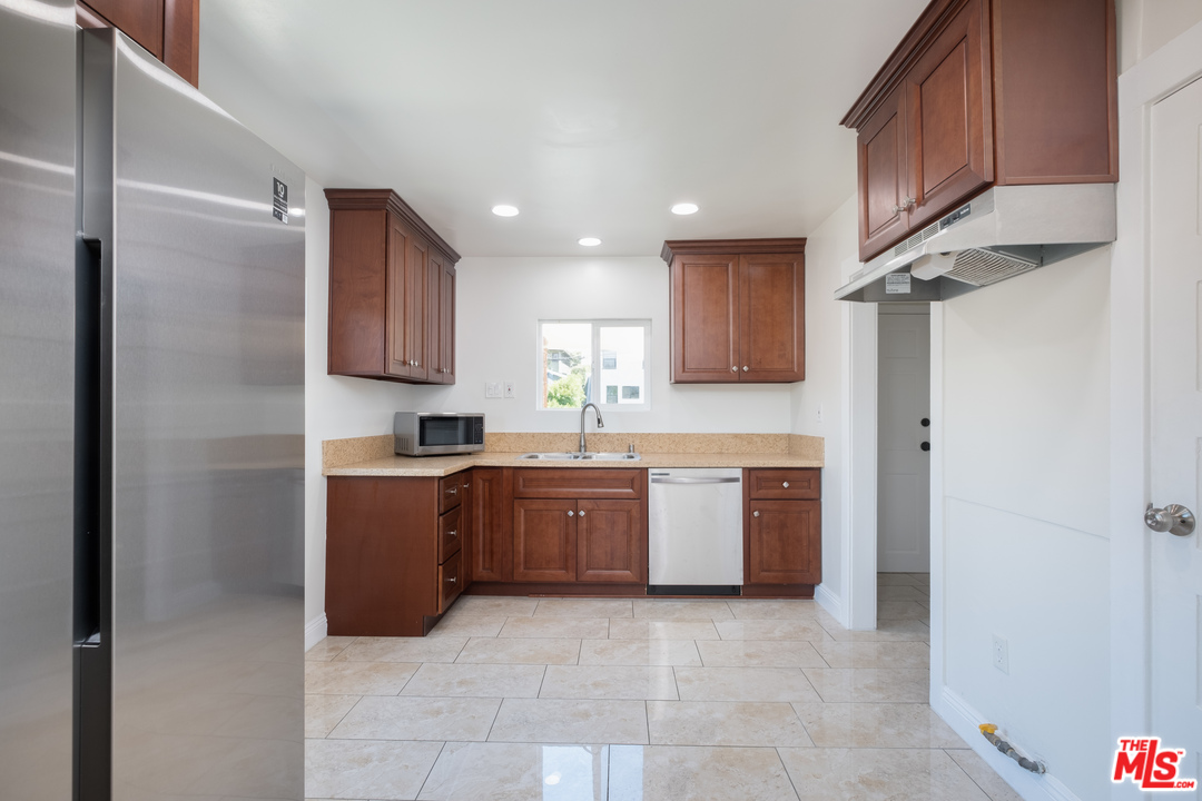 626 Silver Boulevard Los Angeles, CA 90026 - Photo 16 of 24 a large kitchen with stainless steel appliances granite countertop a refrigerator and a sink