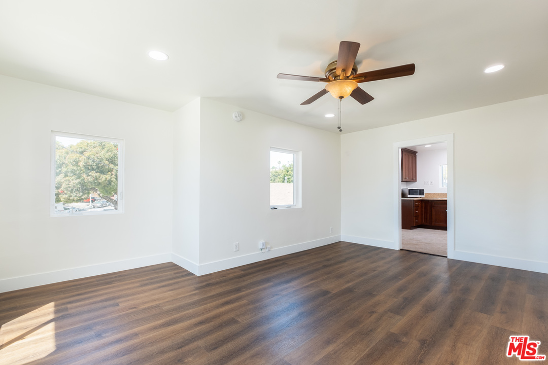 626 Silver Boulevard Los Angeles, CA 90026 - Photo 5 of 24 a view of a workspace with wooden floor and a ceiling fan
