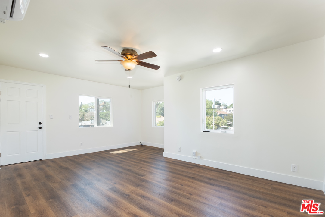 626 Silver Boulevard Los Angeles, CA 90026 - Photo 7 of 24 an empty room with wooden floor and windows