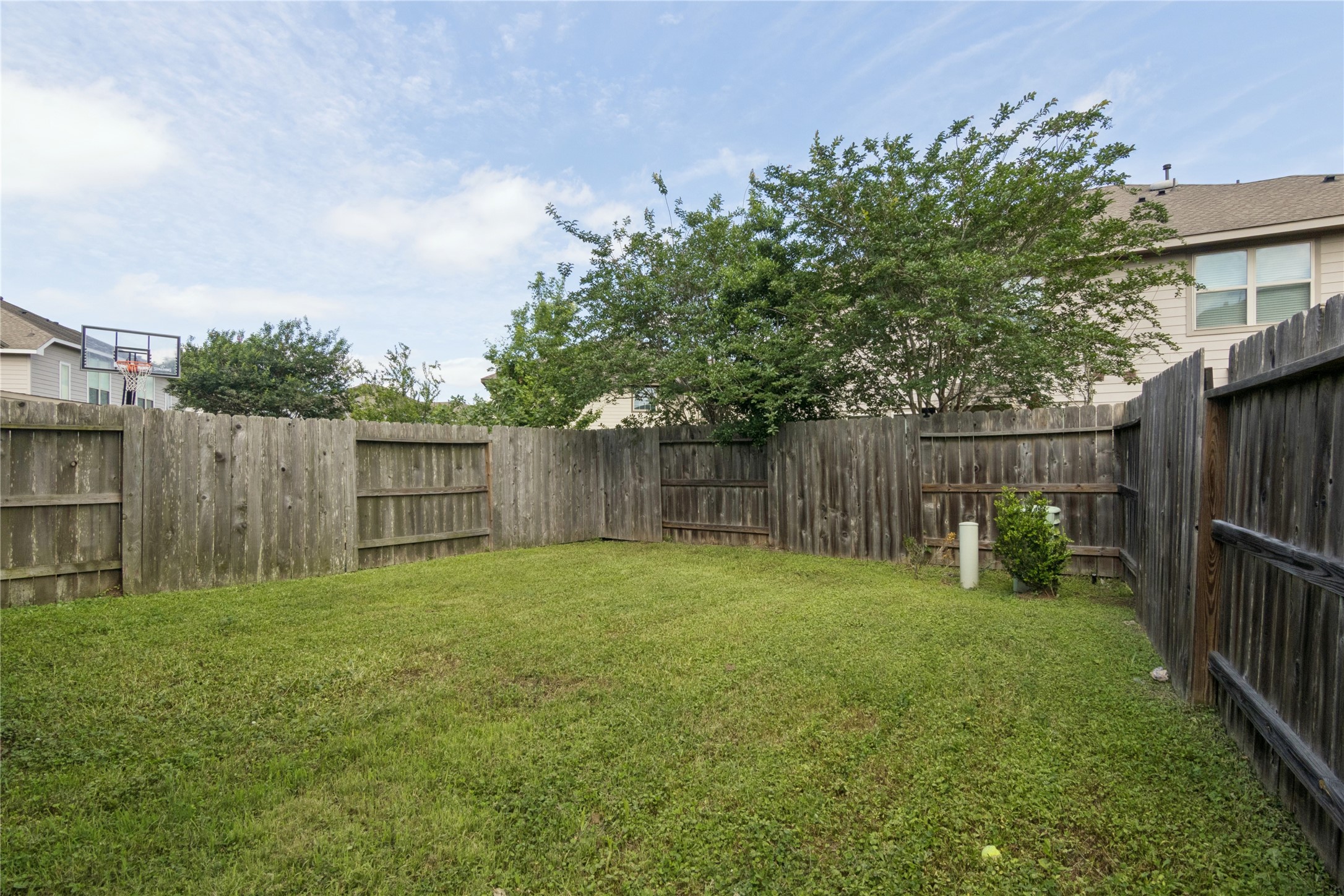 1815 Ryon Falls Drive Richmond, TX 77469 - Photo 24 of 24 a view of a backyard with table and chairs and wooden fence