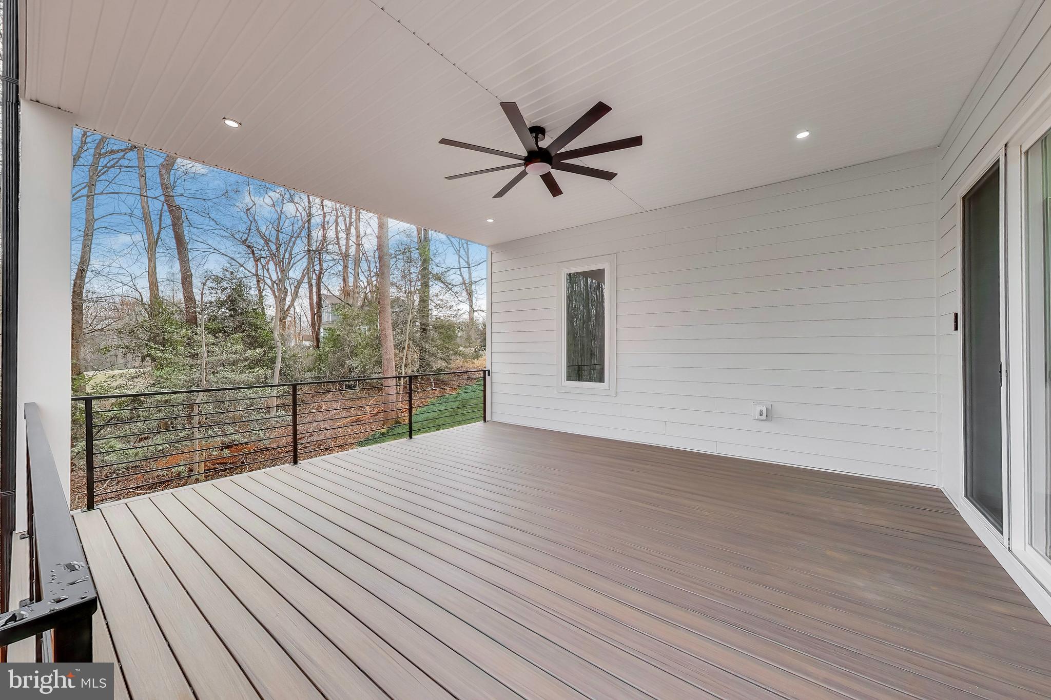 6634 Davis Ford Road Manassas, VA 20111 - Photo 116 of 120 a view of a livingroom with wooden floor and a ceiling fan