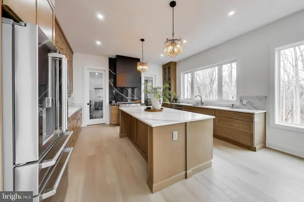 a living room with furniture a fireplace and a large window