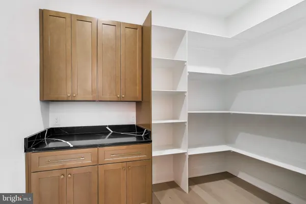 a living room with furniture a window and a potted plant