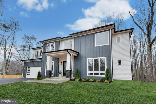 a front view of a house with a yard and porch