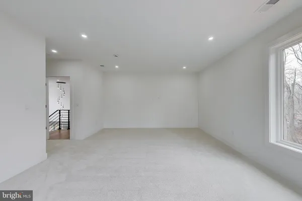 a view of an empty room and a window