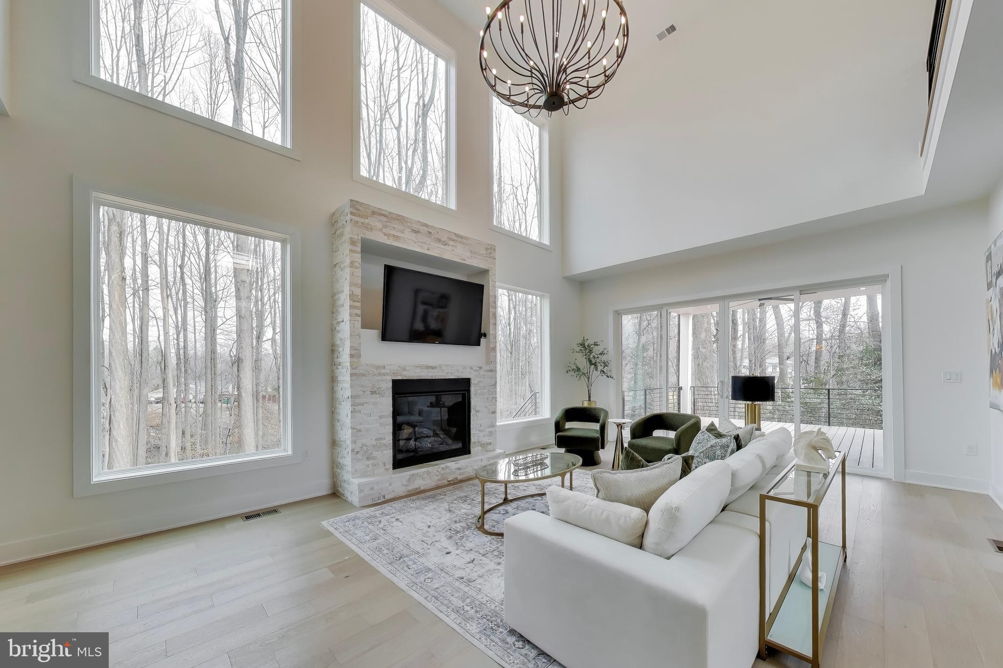 6634 Davis Ford Road Manassas, VA 20111 - Photo 36 of 120 a living room with furniture a fireplace and a large window