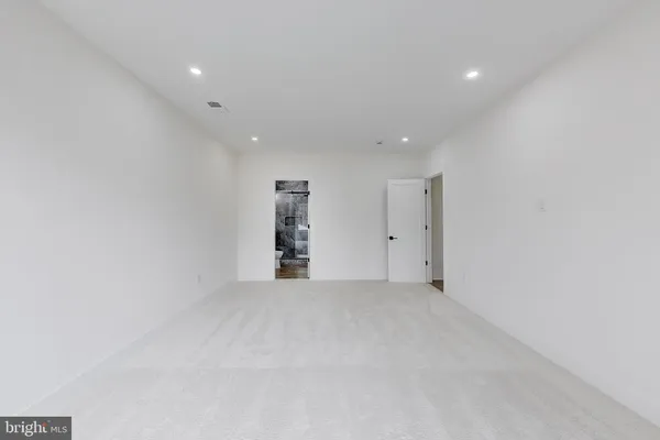 a view of an empty room with a kitchen