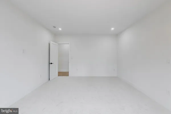 a view of a livingroom with wooden floor and a ceiling fan