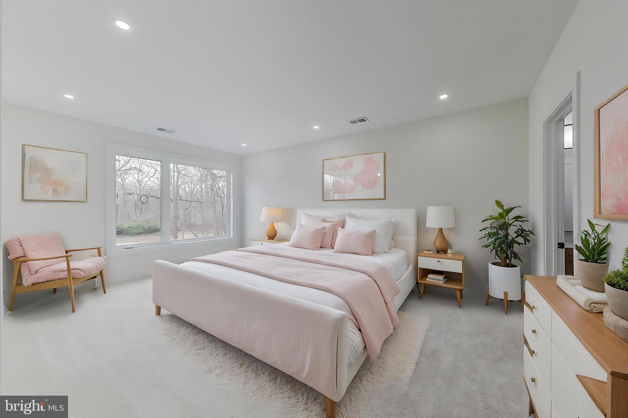 6634 Davis Ford Road Manassas, VA 20111 - Photo 59 of 120 a spacious bedroom with a large bed and a potted plant