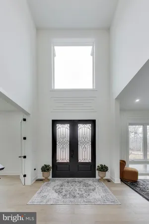a view of entryway livingroom and hall with wooden floor