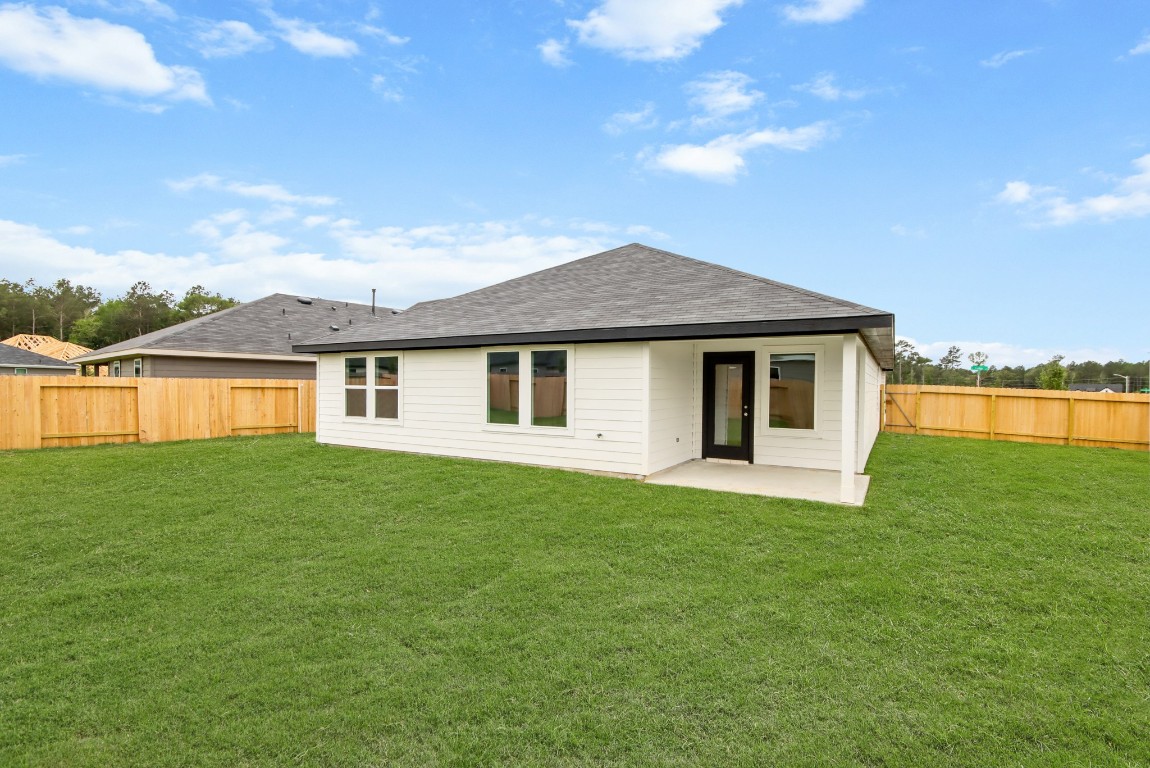 4408 Ledge Court Conroe, TX 77303 - Photo 14 of 26 a front view of a house with a garden