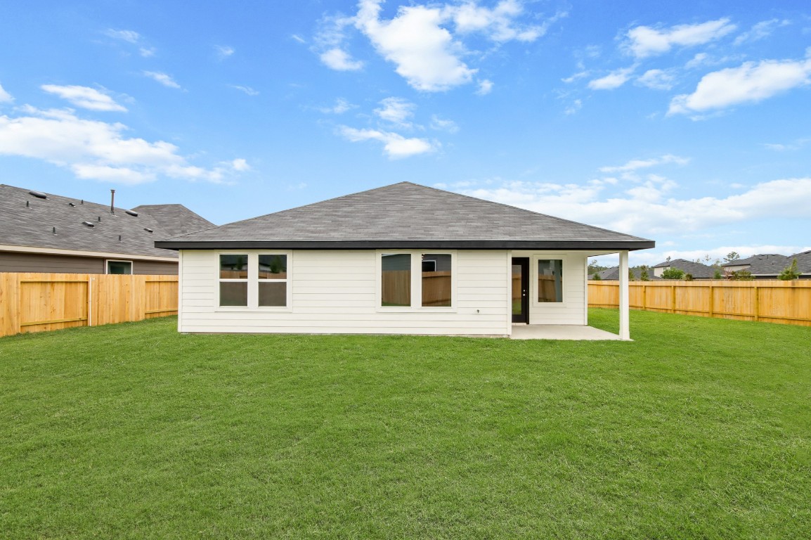4408 Ledge Court Conroe, TX 77303 - Photo 15 of 26 a front view of a house with a garden