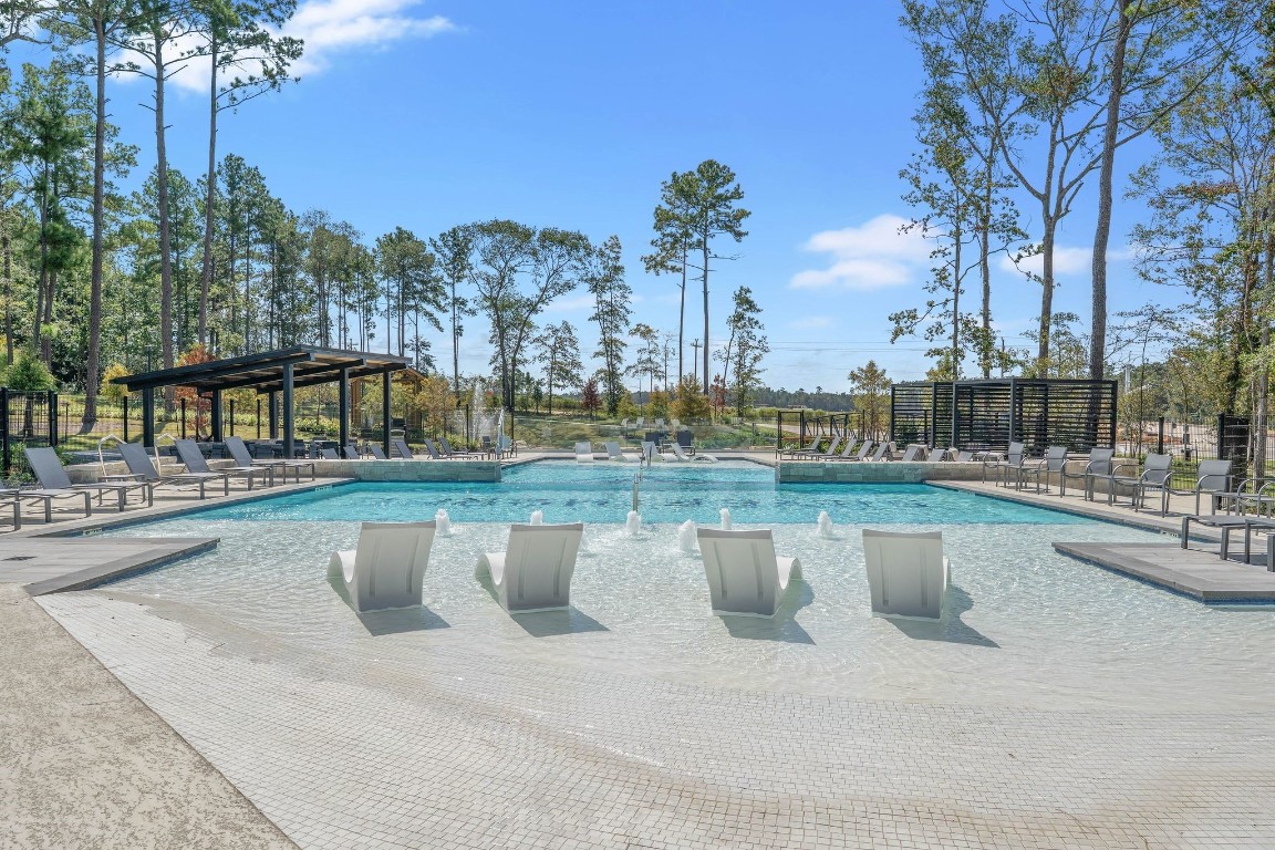 4408 Ledge Court Conroe, TX 77303 - Photo 17 of 26 a view of a swimming pool with a patio