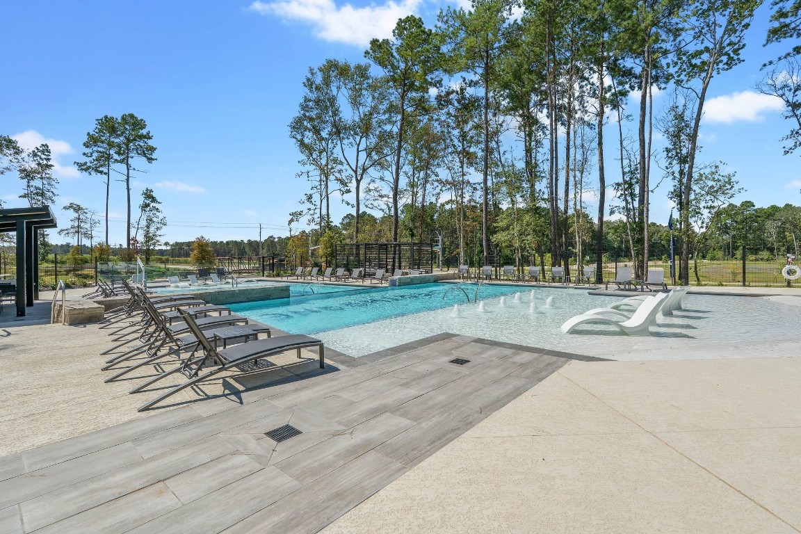 4408 Ledge Court Conroe, TX 77303 - Photo 18 of 26 a view of a park with swings and slides
