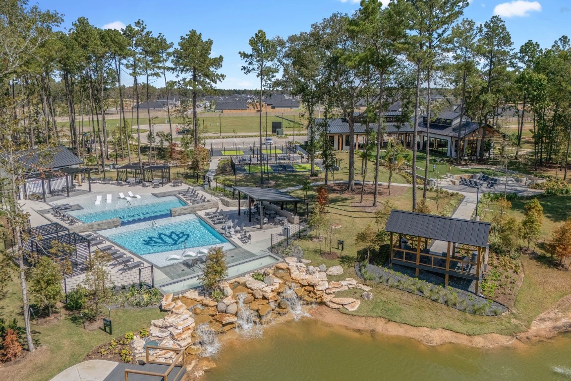 4408 Ledge Court Conroe, TX 77303 - Photo 21 of 26 a view of a lake with couches and wooden fence