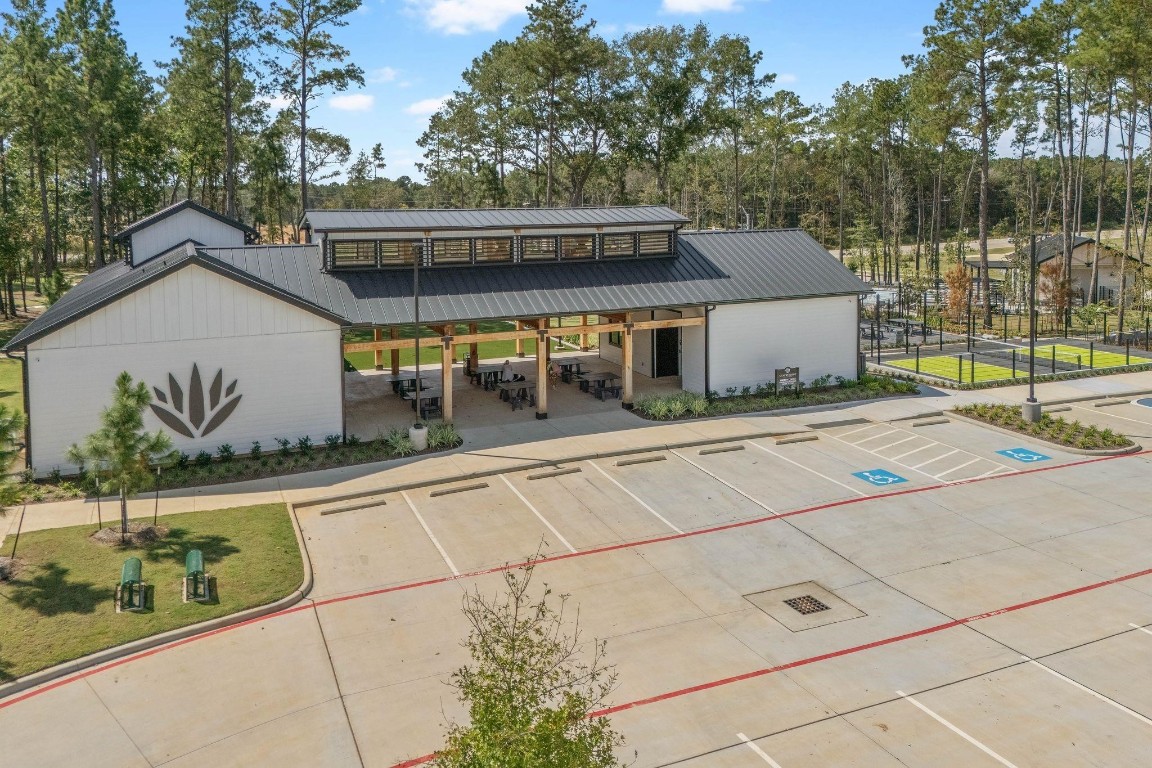4408 Ledge Court Conroe, TX 77303 - Photo 24 of 26 a view of a house with a backyard