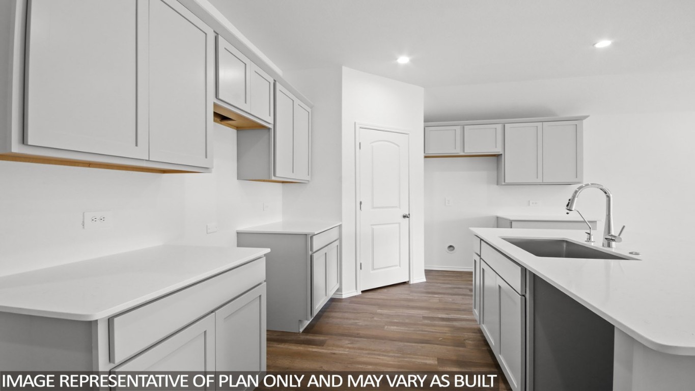 4408 Ledge Court Conroe, TX 77303 - Photo 5 of 26 a kitchen with a sink and cabinets