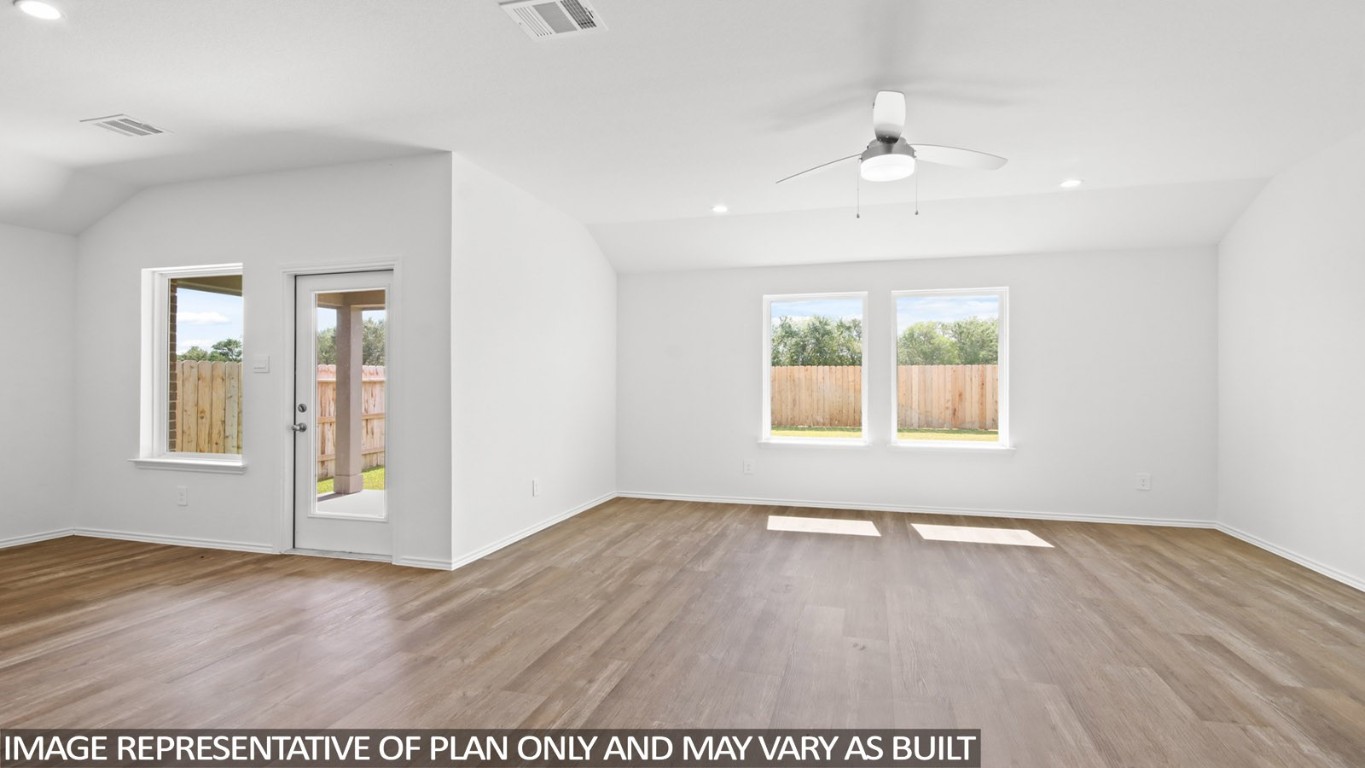 4408 Ledge Court Conroe, TX 77303 - Photo 6 of 26 an empty room with wooden floor and windows