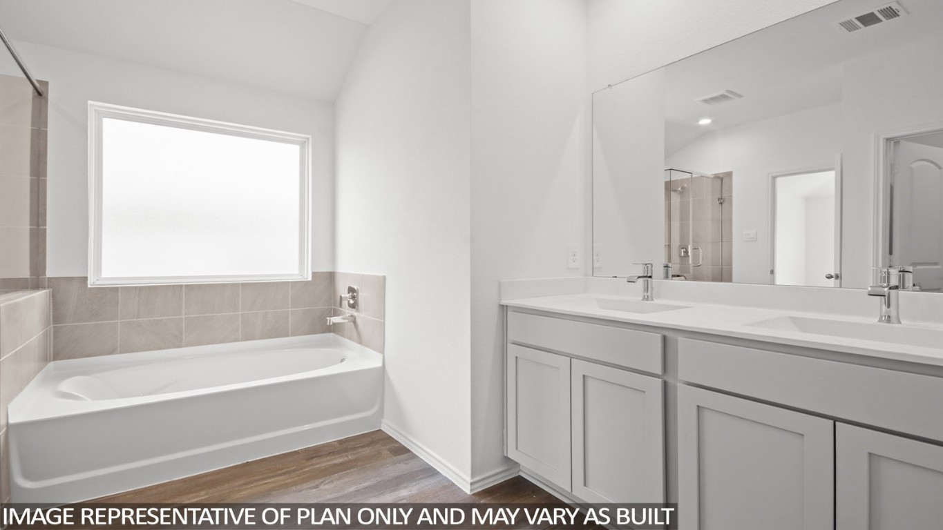 4408 Ledge Court Conroe, TX 77303 - Photo 9 of 26 a bathroom with a tub sink and mirror