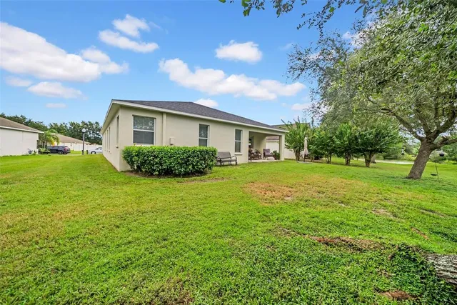a view of house with backyard