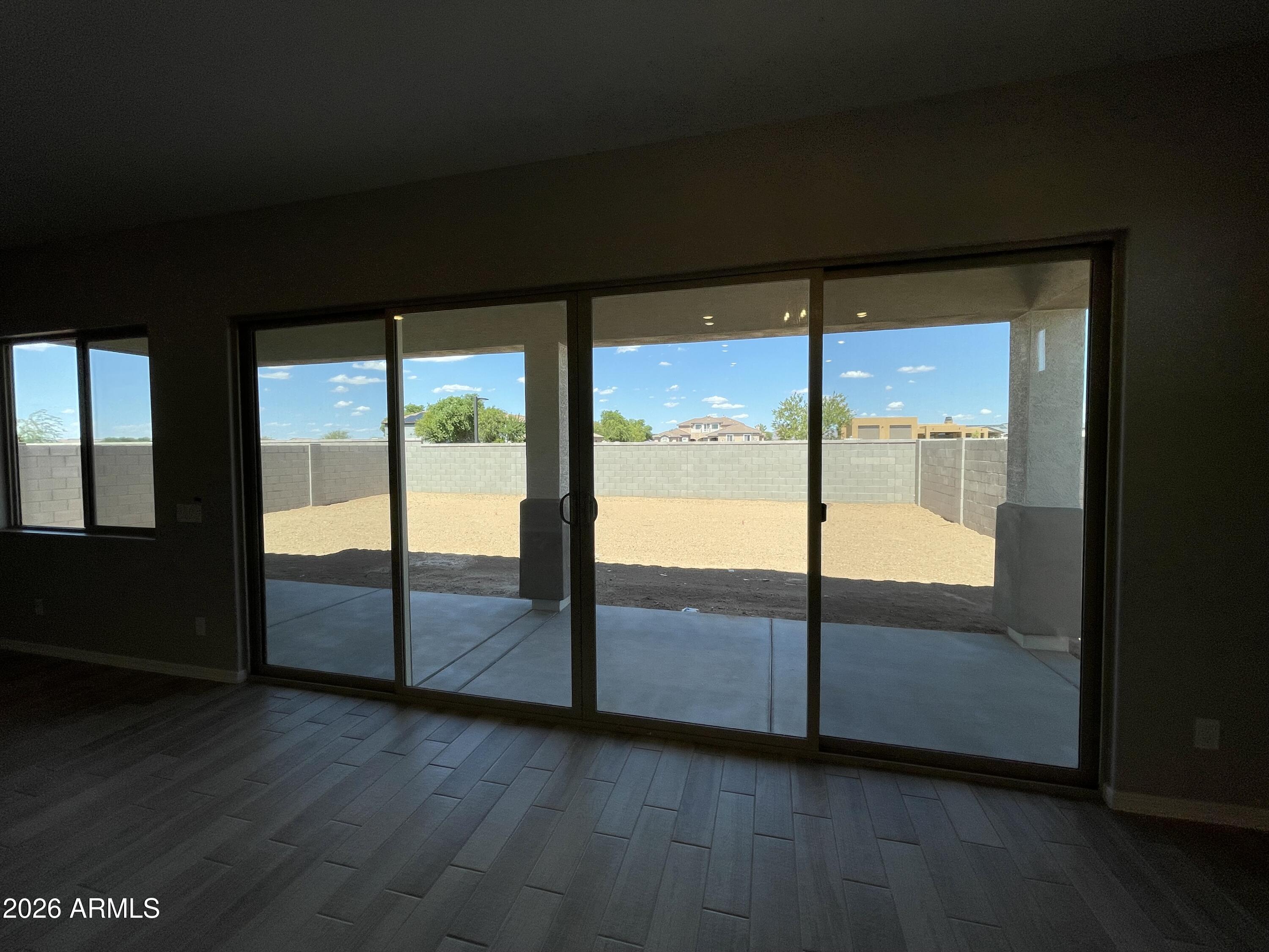 15767 West Sand Hills Road Surprise, AZ 85387 - Photo 11 of 45 a view of an empty room with wooden floor and windows