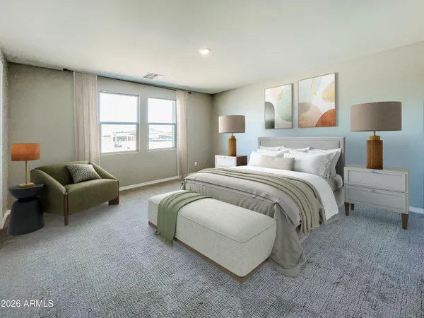 a spacious bedroom with a bed and a couch