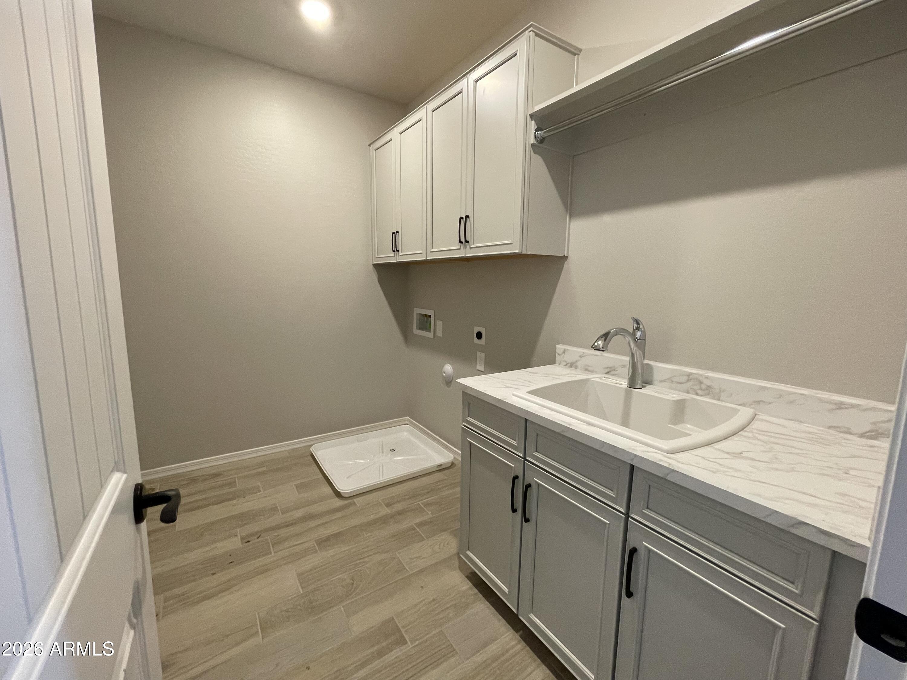 15767 West Sand Hills Road Surprise, AZ 85387 - Photo 19 of 45 a utility room with a sink dryer and washer