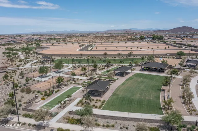 an aerial view of a house with a mountain