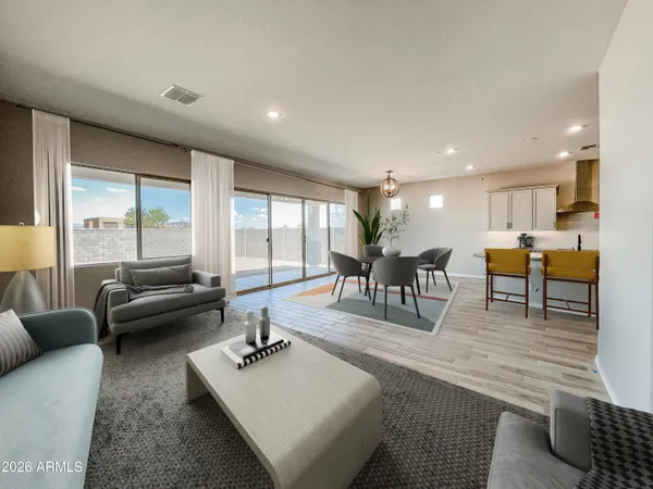 a living room with furniture and a table with wooden floor
