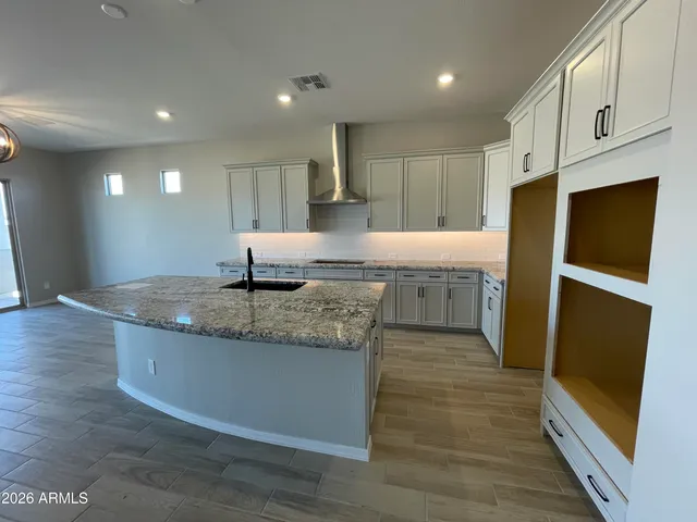 a kitchen with stainless steel appliances granite countertop a sink and a refrigerator
