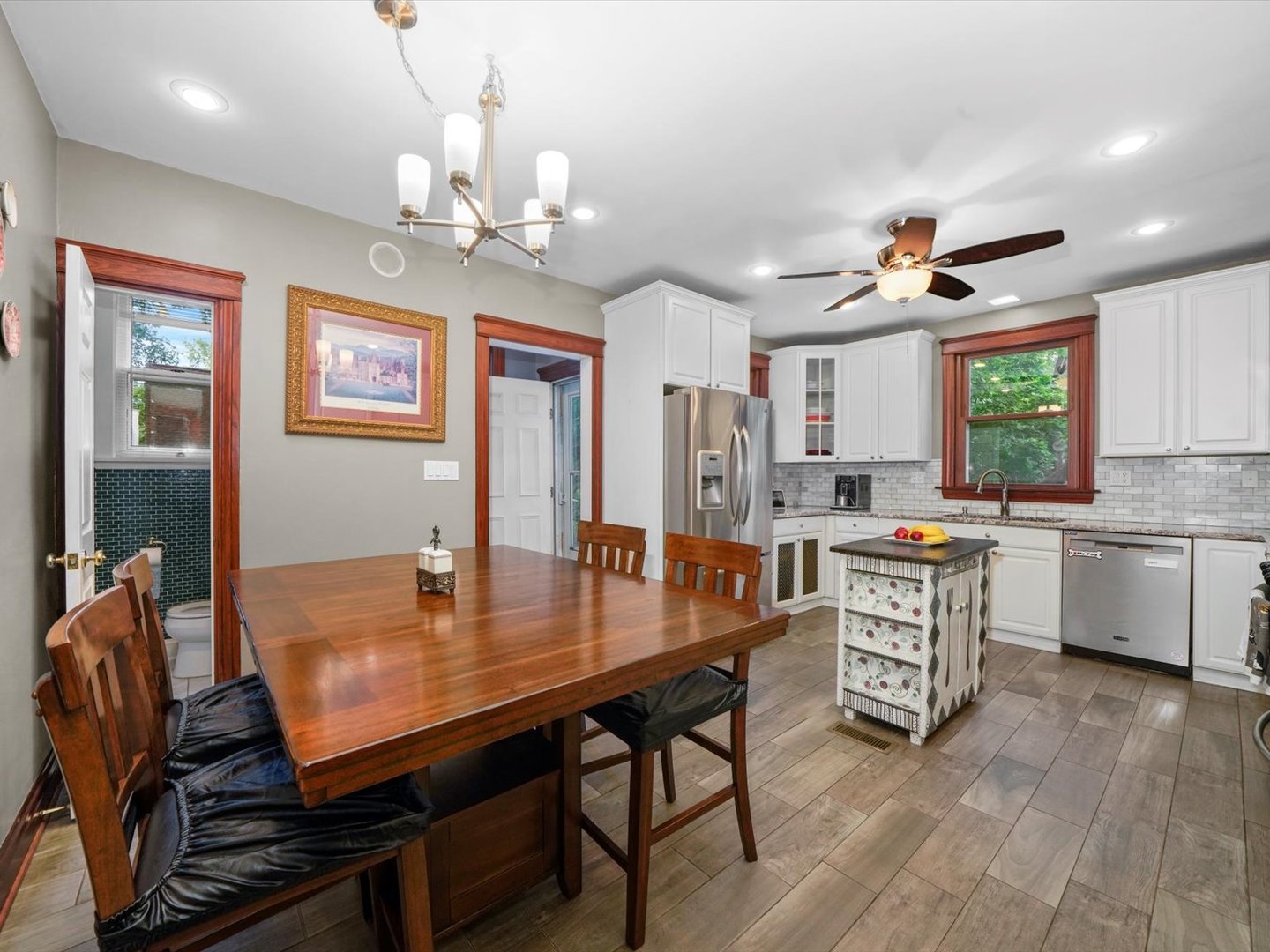 140 Lawton Road Riverside, IL 60546 - Photo 8 of 25 a kitchen with stainless steel appliances granite countertop a stove top oven a sink dishwasher a dining table and chairs with wooden floor