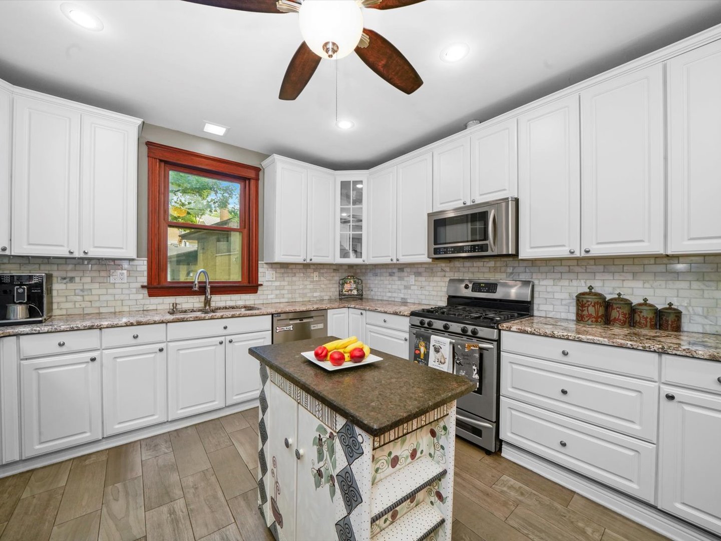 140 Lawton Road Riverside, IL 60546 - Photo 9 of 25 a kitchen with granite countertop stainless steel appliances a stove sink microwave and cabinets