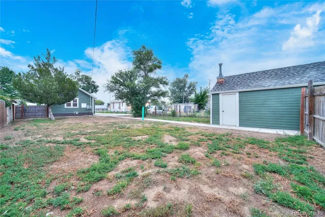 a view of a house with a yard and garage