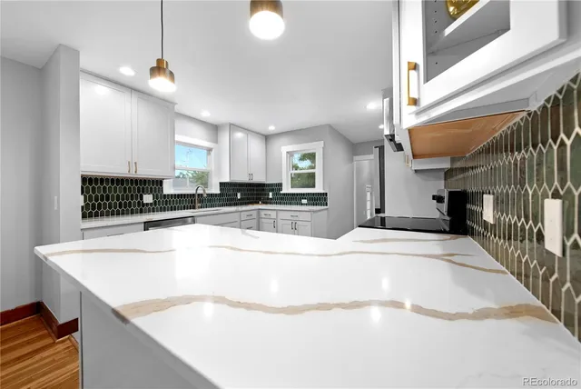 a large kitchen with kitchen island a sink stainless steel appliances and cabinets