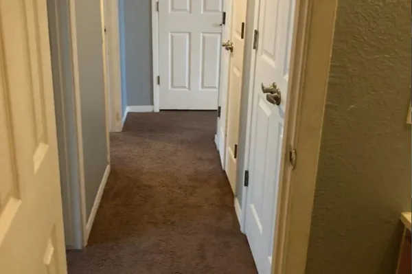 a view of a hallway with a wooden door