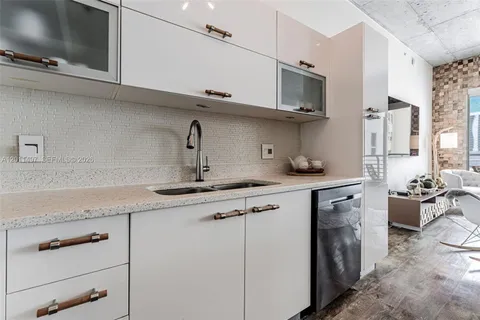 a kitchen with stainless steel appliances granite countertop a sink and a stove