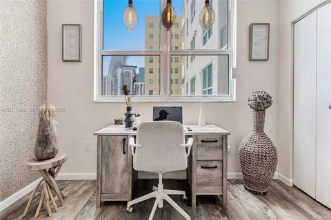 a dining room with furniture and wooden floor
