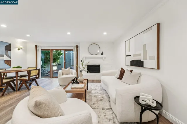 a living room with furniture a fireplace and a window