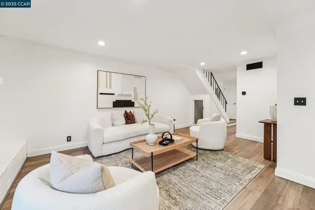 a view of a dining room with furniture large windows and wooden floor