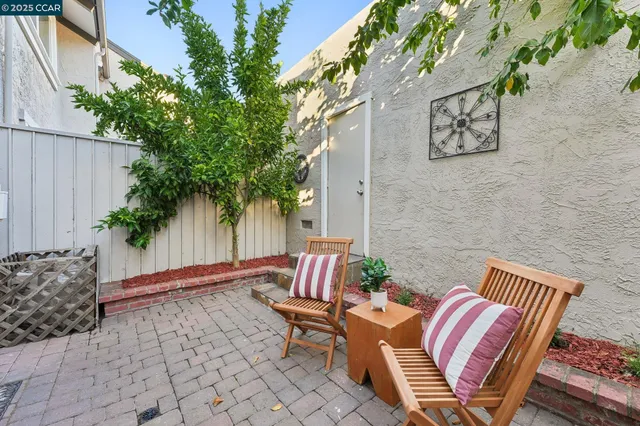 a view of a balcony with chair and the potted plants