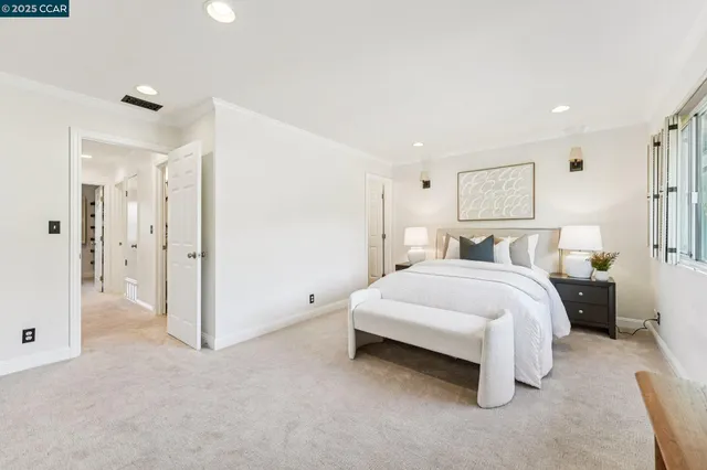 a spacious bedroom with a bed and a large window