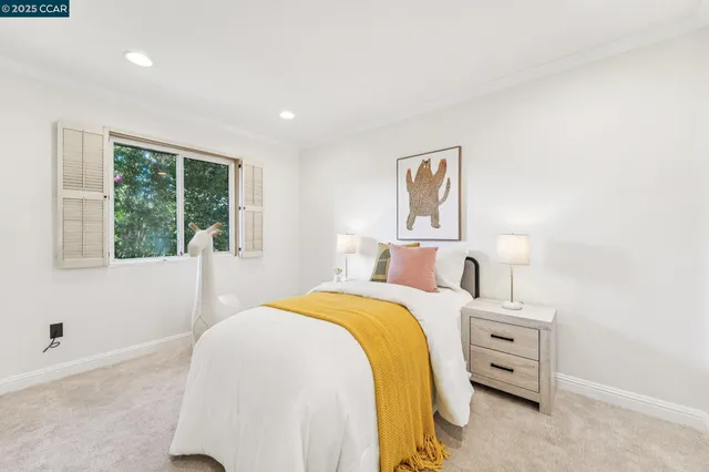 a bedroom with a bed and a window