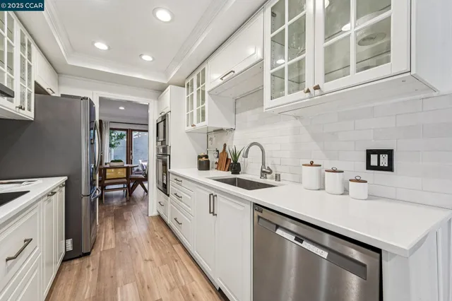 a kitchen with a sink stove and cabinets