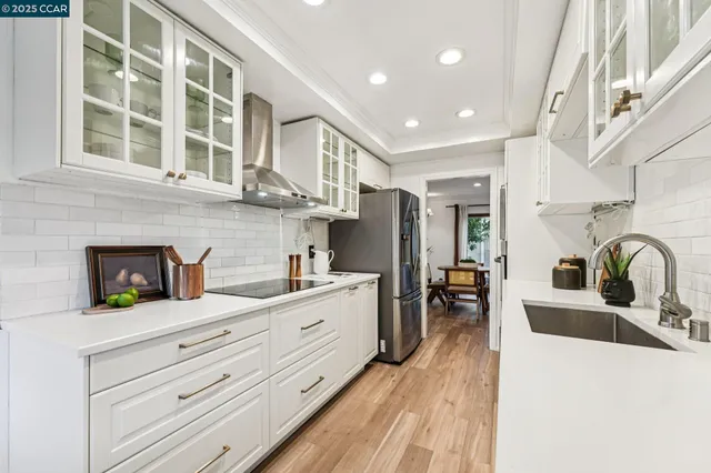 a kitchen with granite countertop a sink and cabinets