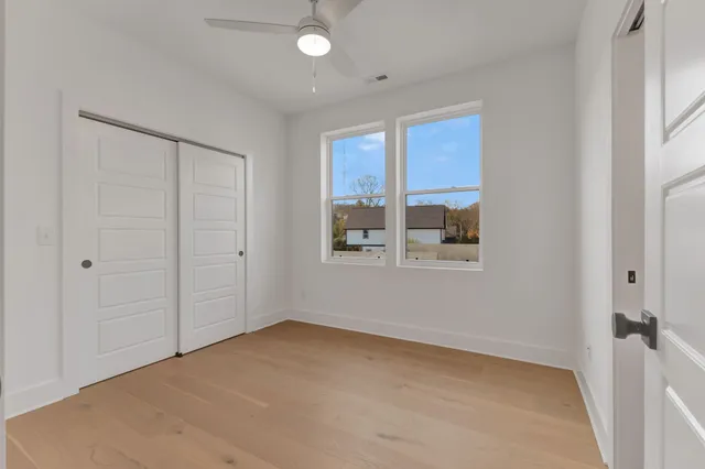 a spacious bathroom with double vanity and a mirror
