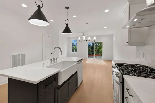 a kitchen with a sink a counter and cabinets
