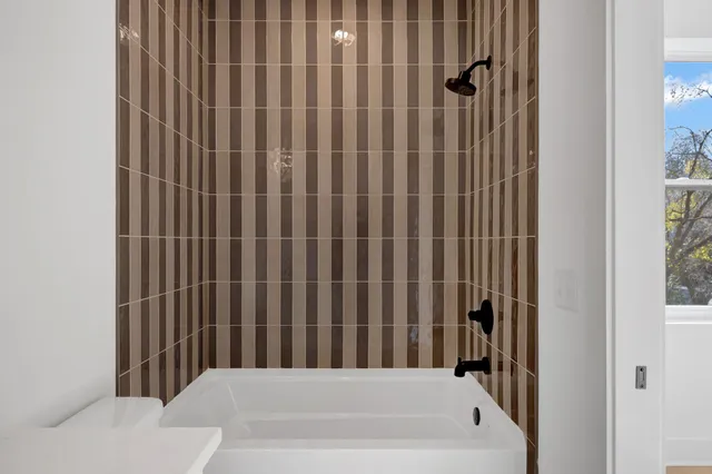 a bathroom with a bathtub and shower