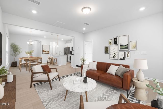 a living room with furniture a flat screen tv and a large window