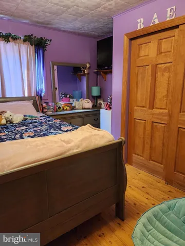 a living room with blue lights with furniture and a kitchen area